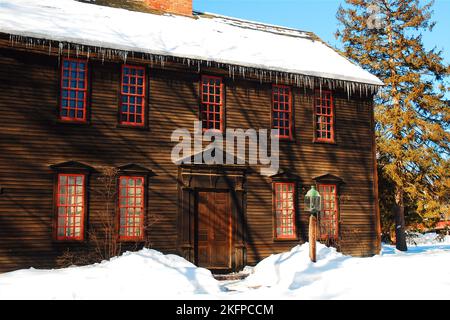 The Ashley House in Deerfield, Massachusetts, once served as the town's schoolhouse, is covered in snow around Christmas Stock Photo