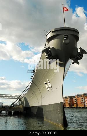 The USS Wisconsin, a decommissioned navy ship, is moored along the waterfront of Norfolk, Virginia Stock Photo