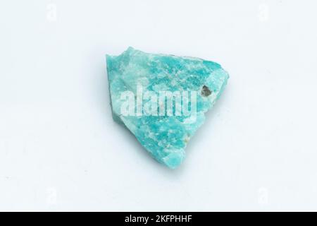 Natural amazonite gemstone isolated on white background. A bluish-green crystal on a white background. A variety of potassium feldspar microcline Stock Photo