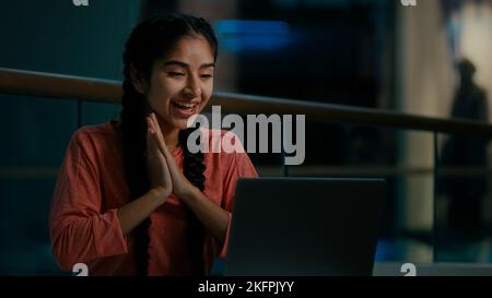 Happy arabian middle-eastern woman student freelancer female shopper sit in shopping center work on computer e-learning chatting online receive email Stock Photo