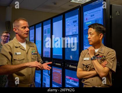 SANTA RITA, Guam (Sep. 30, 2022) – Cmdr. Jason Paradis, officer in charge of Naval Submarine Training Center Pacific (NSTCP), Detachment Guam, describes the training facility’s capabilities to Rear Adm. Su Youl Lee, commander, Republic of Korea (ROK) Navy Submarine Force during the 55th Submarine Warfare Committee Meeting (SWCM), Sept. 30, 2022. Over the past 28 years, SWCM has brought together leaders of both the U.S. and ROK submarine forces to discuss combined submarine training and force integration. Stock Photo