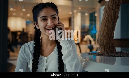Smiling arabian middle-eastern woman buyer customer student businesswoman ethnic girl lady spend weekend at shopping mall business center answer Stock Photo