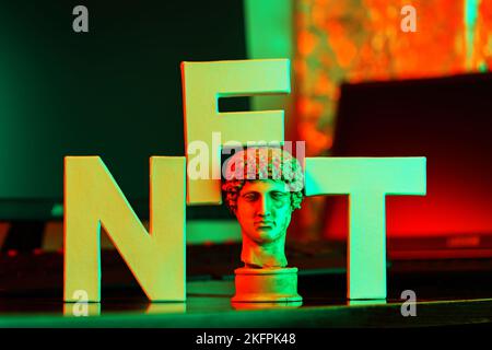 NFT (Non-Fungible token) and antique sculpture in neon light. Concept of cryptoart and blockchain technology Stock Photo