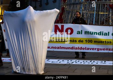 Madrid, Spain. 19th Nov, 2022. A woman is seen performing under a sheet during a protest against the FIFA World Cup Qatar 2022. People gathered to protest under the slogan 'No to the world cup of shame' denouncing that in the construction of infrastructures at least 6,500 immigrant workers have died. Credit: Marcos del Mazo/Alamy Live News Stock Photo