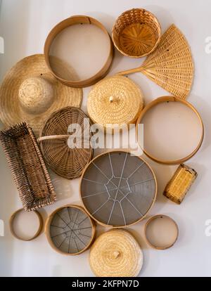 Handicraft handmade from natural products, wicker basket bamboo fan straw hat Stock Photo