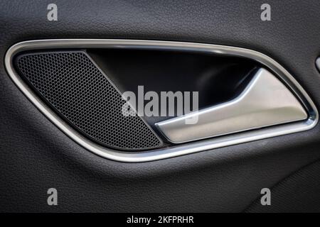 Door handle with Power seat control buttons of a luxury passenger car. White leather interior of the luxury modern car. Modern car interior details Stock Photo