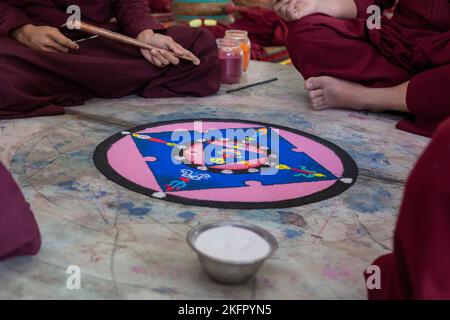 Young monks from Shechen Tennyi Dargyeling Monastery create a sand mandala. Kathmandu. Nepal. Stock Photo