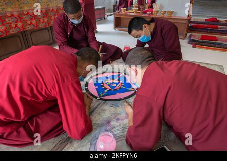 Young monks from Shechen Tennyi Dargyeling Monastery create a sand mandala. Kathmandu. Nepal. Stock Photo