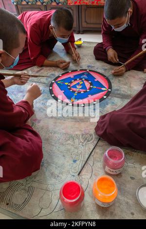 Young monks from Shechen Tennyi Dargyeling Monastery create a sand mandala. Kathmandu. Nepal. Stock Photo