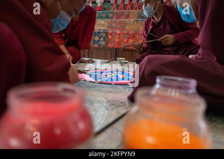 Young monks from Shechen Tennyi Dargyeling Monastery create a sand mandala. Kathmandu. Nepal. Stock Photo