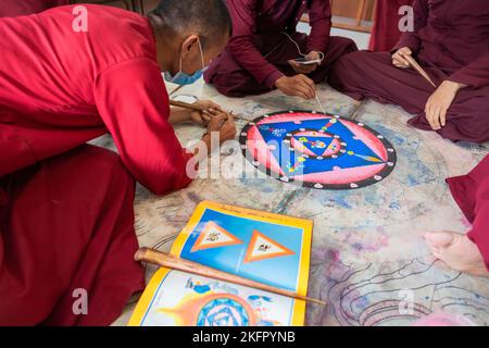 Young monks from Shechen Tennyi Dargyeling Monastery create a sand mandala. Kathmandu. Nepal. Stock Photo