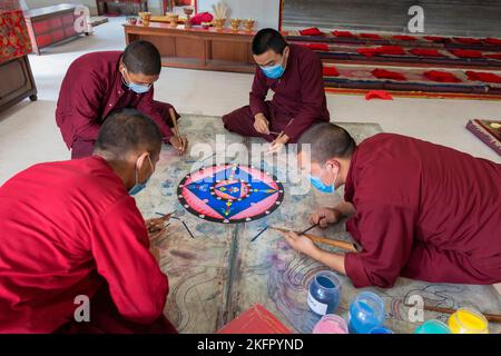 Young monks from Shechen Tennyi Dargyeling Monastery create a sand mandala. Kathmandu. Nepal. Stock Photo