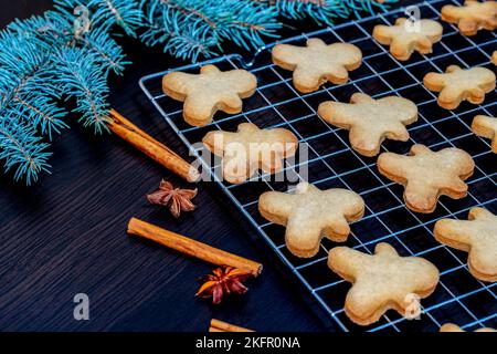 Freshly baked gingerbread man shaped biscuits with Christmas decoration Stock Photo