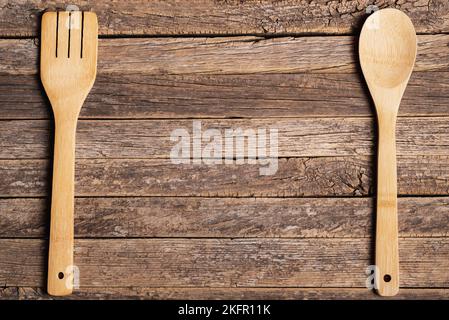 Wooden spoon and fork on old rustic wooden table. Stock Photo