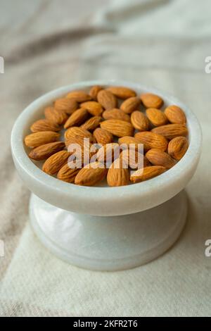 Close-up of almonds on a beautiful stand, Nuts are healthy. Organic food. Stock Photo