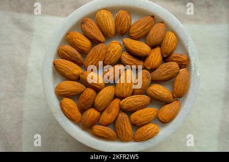 Close-up of almonds on a beautiful stand, Nuts are healthy. Organic food. Stock Photo