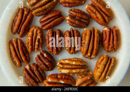 Walnut plan, pecan halves on a beautiful stand, Nuts are healthy. Organic food. Stock Photo