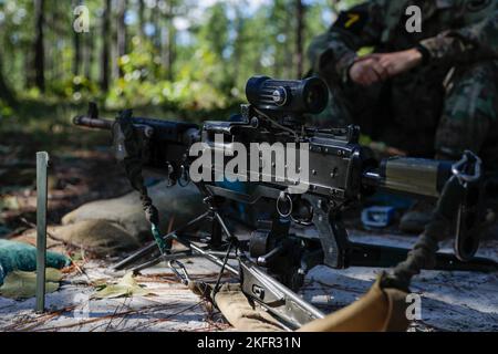 An M240L machine gun sits on a M192 Lightweight Ground Mount tripod as Soldiers of Squad 7, representing the U.S. Army Reserve, train on its use during the Army’s first-ever Best Squad Competition on Fort Bragg, North Carolina, Oct 2, 2022. The Army Best Squad Competition succeeds the Army Best Warrior Competition and extends the competing element from the individual level to the squad level, as Soldiers never fight alone; the unbreakable bonds forged through shared hardship and unending support for one another are the hallmark of our most successful small units. Stock Photo