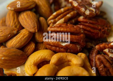 Mix Walnuts, pecan, almonds, cashews on a beautiful stand, Healthy Nuts. Organic food. Stock Photo