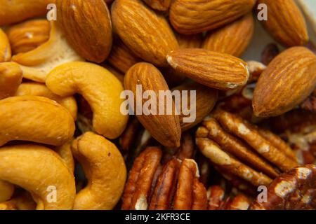 Mix Walnuts, pecan, almonds, cashews on a beautiful stand, Healthy Nuts. Organic food. Stock Photo
