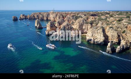 Aerial drone view of boats and kayaks in the Atlantic Ocean, Lagos, Algarve, Portugal. Exploring caves and tunnels. Travel and adventure. Holidays. Stock Photo