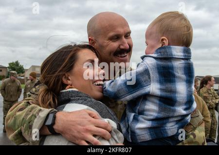 Capt. Ben Bertelson, center, 3rd Airlift Squadron C-17 Globemaster III pilot, hugs his wife Amanda and son Beau upon returning to Dover Air Force Base, Delaware, Oct. 3, 2022. Members from the 3rd AS, 436th Mission Generation Group and 436th Security Forces Squadron were greeted by family, fellow squadron and Team Dover members after a deployment to Al Udeid Air Base, Qatar. Stock Photo