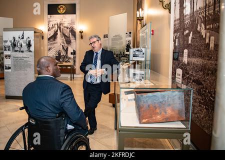 Rob Gainer (right), historian, Arlington National Cemetery, gives a tour of the Memorial Amphitheater Display Room to U.S. Army Col. (ret.) Gregory Gadson (left) at Arlington National Cemetery, Arlington, Va., Oct. 4, 2022. Gadson was at ANC to speak to employees as part of the National Disability Employment Awareness Month. He also participated in a Public Wreath-Laying Ceremony at the Tomb of the Unknown Soldier. Gadson has dedicated himself to the work of Wounded Warriors, veterans, and other groups who support employment and betterment of person with disabilities. Stock Photo