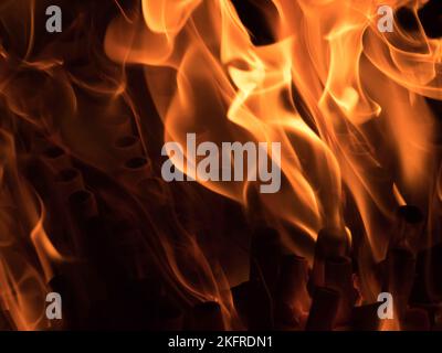 Firework mortor repeater tubes on fire with flames close-up. Stock Photo