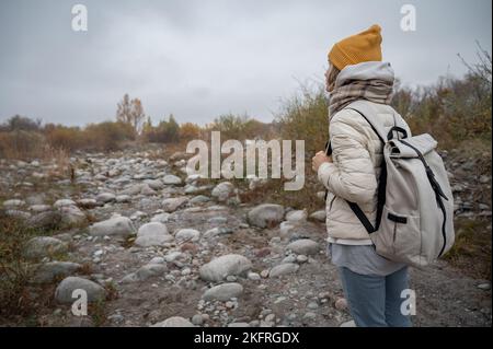 Slow and not deep mountain river with rounded stones Stock Photo