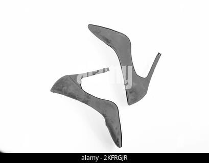 Footwear with thin high heels, stiletto shoes, top view. Pair of fashionable high heeled pump shoes. Shoes made out of red suede on white background Stock Photo