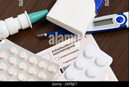 Stuttgart, Germany. 18th Nov, 2022. A fever thermometer, medication and a doctor's certificate of incapacity for work (sick note) are lying on a bedside table (posed scene). With the cold season, influenza infections are on the rise again. Credit: Bernd Weißbrod/dpa/Alamy Live News Stock Photo