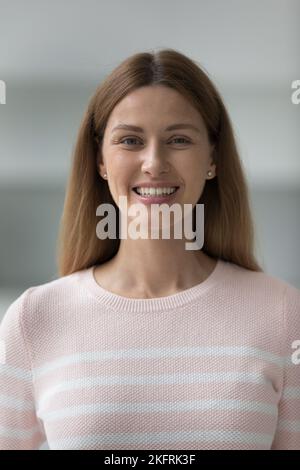 Vertical shot beautiful young woman smile staring at camera Stock Photo
