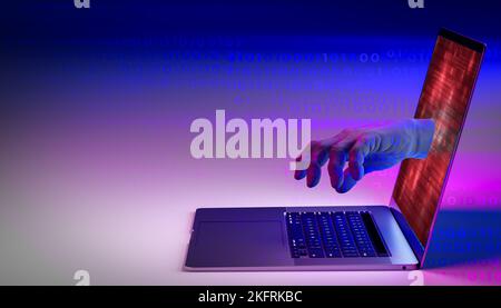 Internet crime. Hacker hand reach through laptop screen for stealing data. Cyber attack, virus, malware, illegally and cyber security. colorful bright Stock Photo