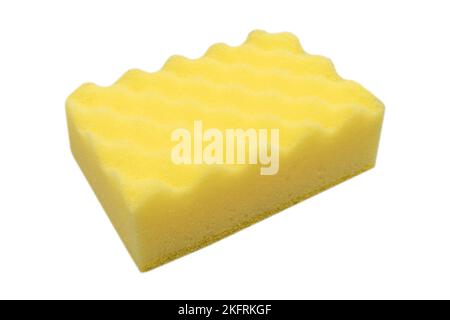 Macro shot of a surface of yellow sponge isolated onwhite background. Close-up texture. Yellow scrub sponge. Sponge texture background. Yellow sponge Stock Photo