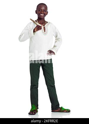 In touch with my heritage. Full length studio portrait of a young african teenage boy isolated on white. Stock Photo