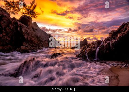 Scene of beautiful sunset and sea waves at banana beach, Phuket , Thailand. Stock Photo