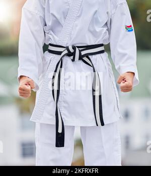 Karate, fitness and body of woman in martial arts training for competition with hands fist, fight and commitment in Japanese culture. Power, challenge Stock Photo