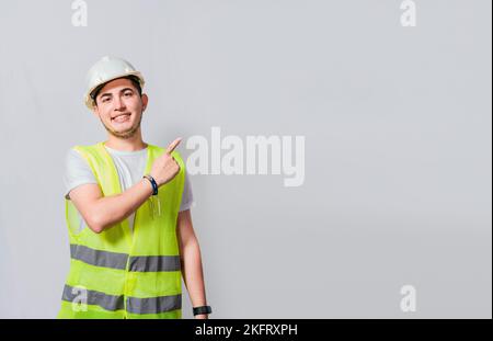 Engineer man pointing to side. Builder engineer pointing finger to the right isolated, Portrait of engineer man pointing aside, Construction engineer Stock Photo