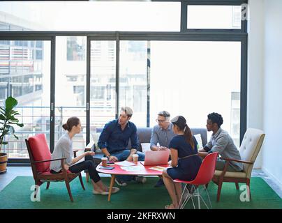 Strategy sesh. a group of office workers talking together in a meeting room. Stock Photo