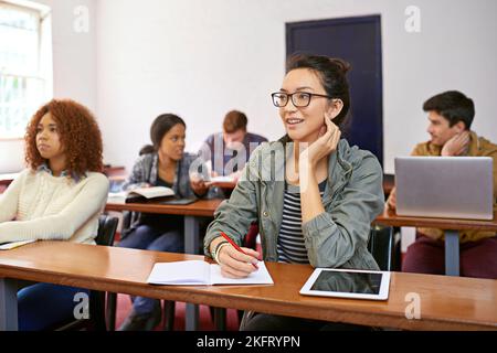 Some people are on their way to success...two students paying attention in class while their peers are chatting behind them. Stock Photo