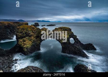 Gatklettur at sunrise, rock arch in the sea, Arnarstapi, Snäfellsnes Peninsula, West Iceland, Iceland, Europe Stock Photo