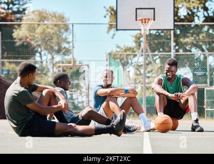 Basketball court, friends and men, break and team sports, social conversation and relax in community playground. Basketball players, rest and black Stock Photo