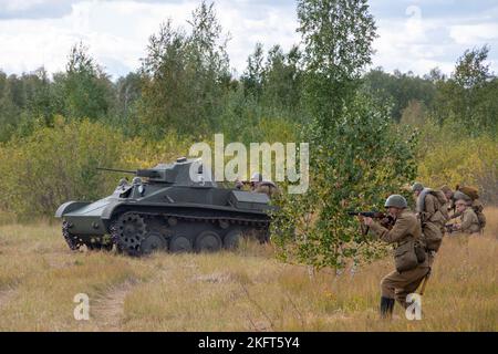 Attack of Soviet T25 tank and Soviet soldiers with rifles. Reconstruction of the battle of World War II. Russia, Chelyabinsk region, September 12, 202 Stock Photo
