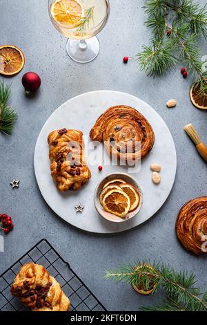 Top view of delicious homemade baked assorted pastries placed on plate with Christmas decoration around Stock Photo
