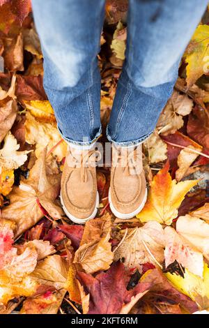 Boots of person standing on fallen leaves Stock Photo - Alamy