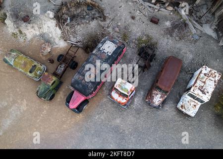 From above drone view of corroded vehicles located on junkyard in daytime in USA Stock Photo