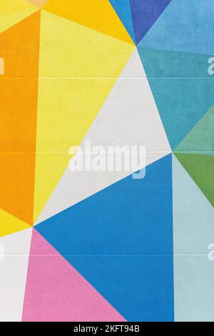 From below of colorful geometric building with colorful geometric ornament and windows on wall in city Stock Photo