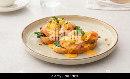 Portion of eggs benedict toast with salmon Stock Photo