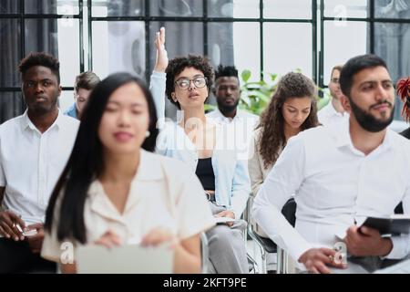 conducts business training with a group of young people. Stock Photo
