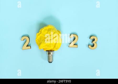 New year 2023 innovation, creativity in business ideas concept. 2023 text with bright yellow light bulb. Stock Photo